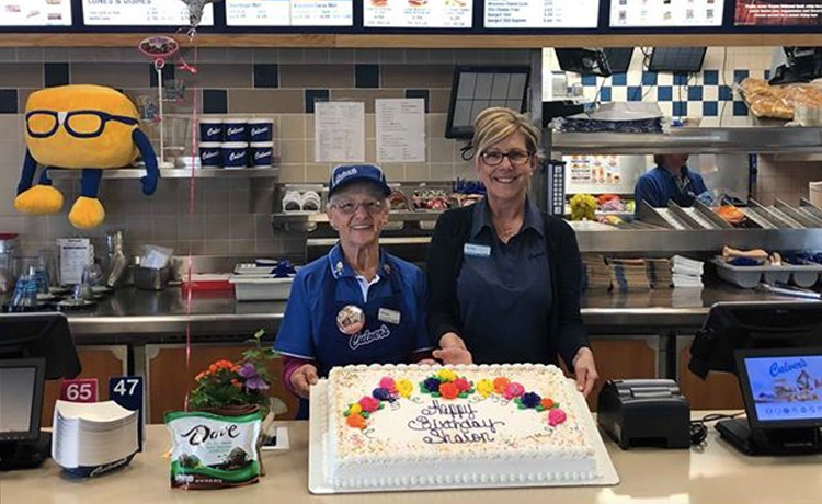 Team Member Sharon in Culver's holding a cake.