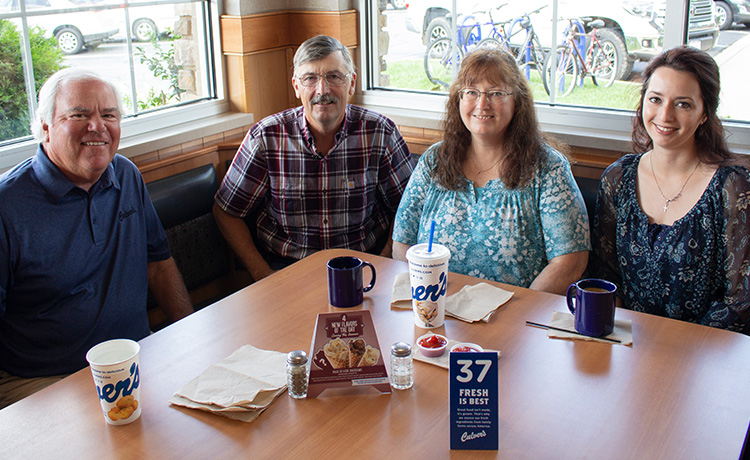 Craig Culver enjoys a meal in a corner booth with first guest Jim Olson, Jim’s wife Marion and their daughter Heather.
