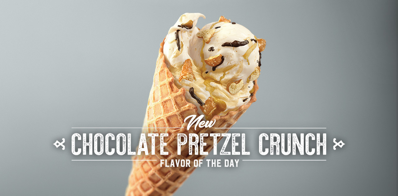 The New Chocolate Pretzel Crunch Flavor of the Day in a cone with a grey background