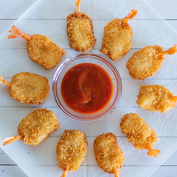 Instagram Post: Butterfly shrimp arranged in a circle around a dish of cocktail sauce